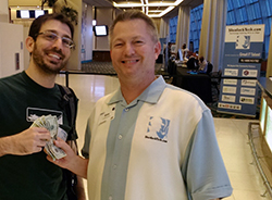 Alex Hands Over the Cash – SherlockTech Pokerchip Winner@Dolphins